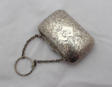 A white metal purse of rectangular form engraved with flowers and leaves, on a ring and chain