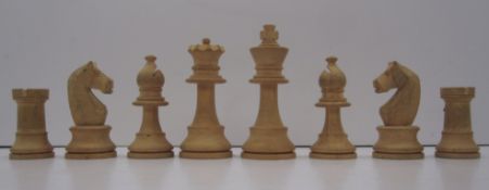 A "Staunton" pattern chess set, one side ebonised, the opposing natural, the kings with Maltese