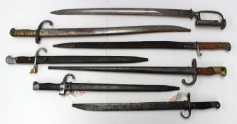 A Japanese Arisaka bayonet and scabbard together with six other bayonets.