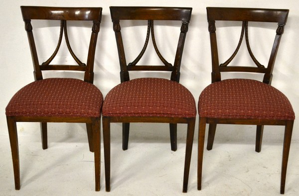 A SET OF THREE 19TH CENTURY CONTINENTAL OAK SIDE CHAIRS the back with arched top rail above carved