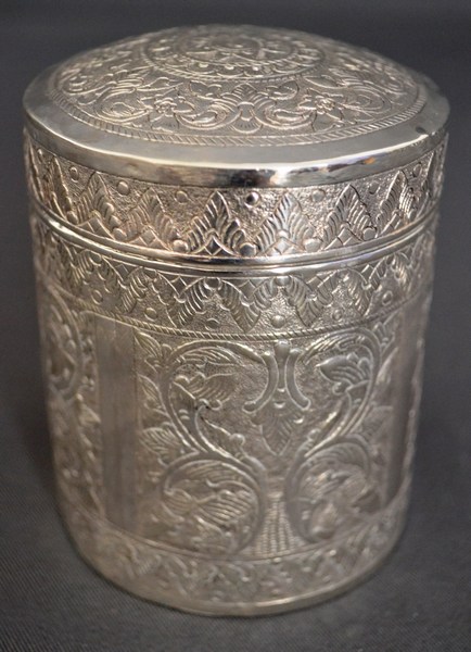A 19TH CENTURY PERSIAN SILVER HOLDER with detachable lid, circular body profusely engraved with
