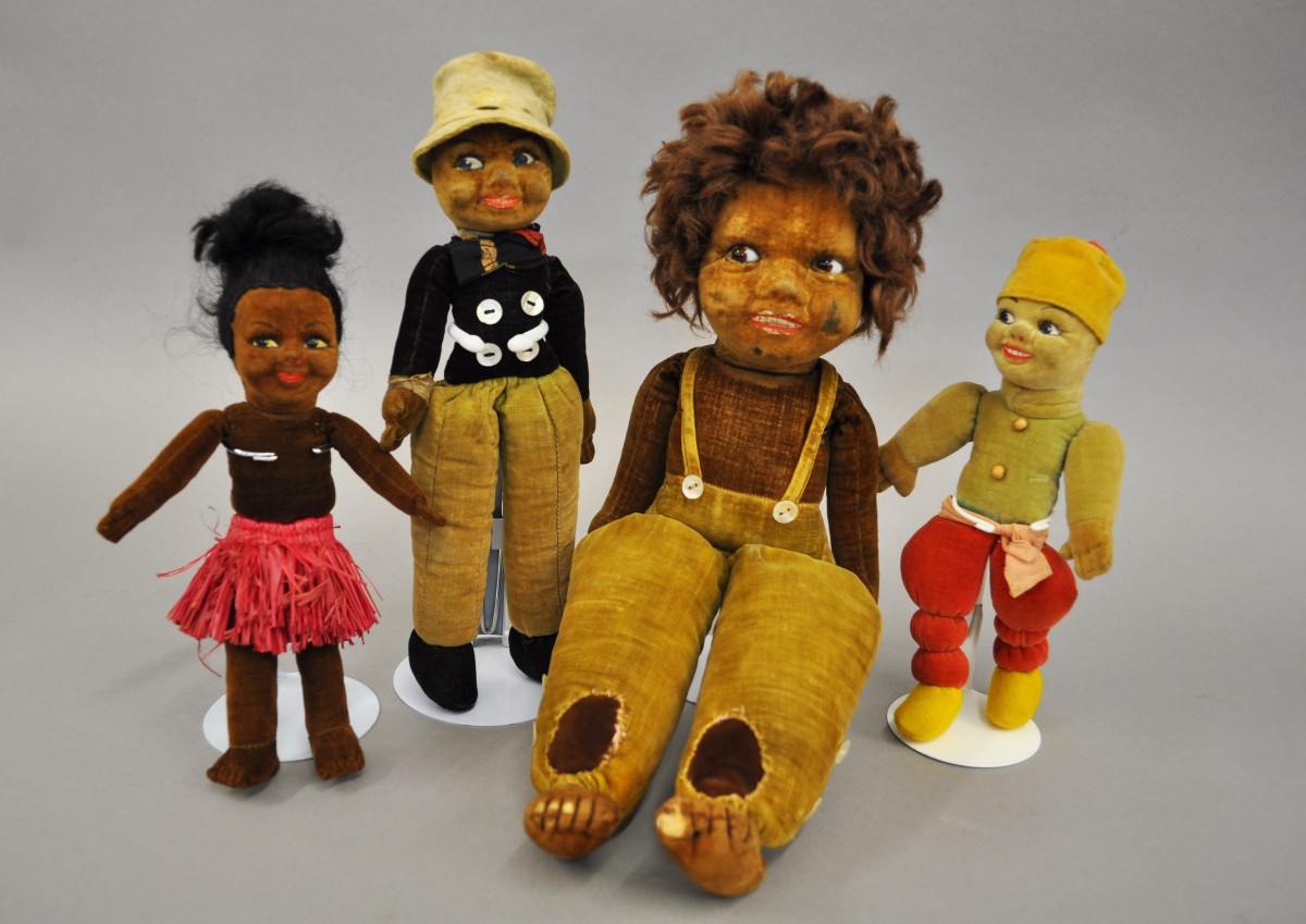 Four Norah Wellings velveteen cloth dolls, includes South Sea Islander with side-glancing brown