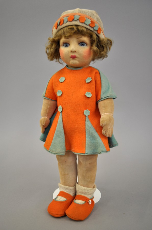 Chad Valley felt Doll: moulded felt face with blue glass eyes and painted features, dark blonde wig,