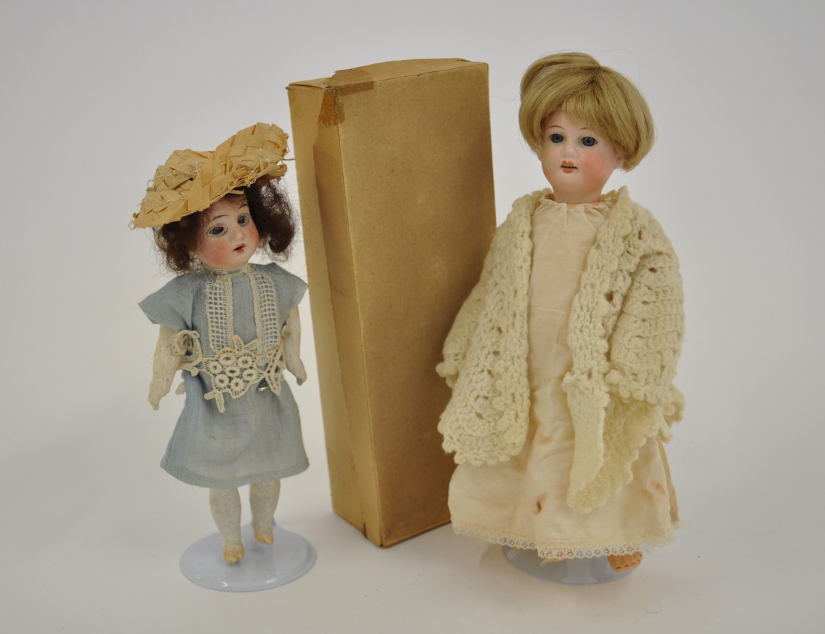 Two small late 19th/early 20th Century bisque head girl dolls: the first impressed "Made In
