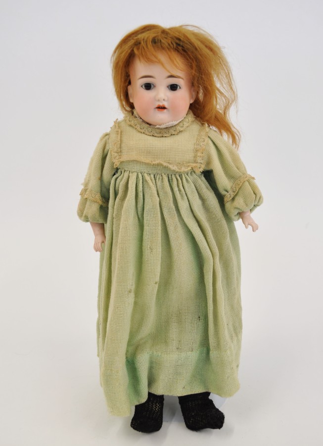 Late 19th Century bisque shoulder-head girl doll by Cuno & Otto Dressel with fixed brown eyes,