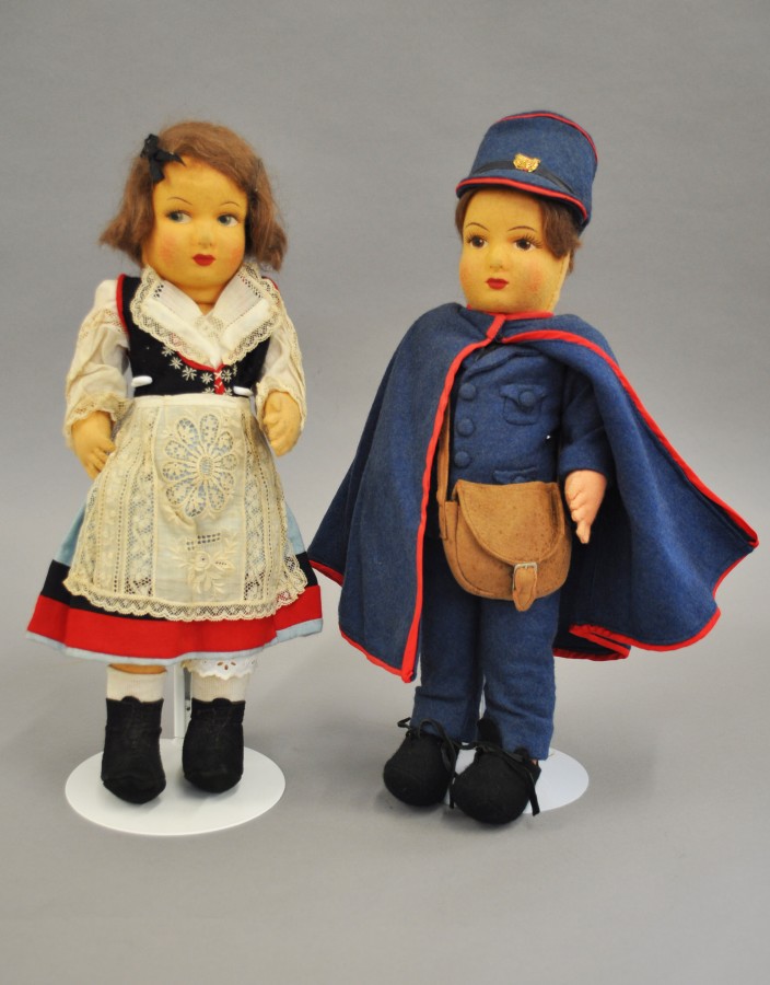 Two felt dolls, with moulded faces and painted features: one Postman in blue felt jacket,