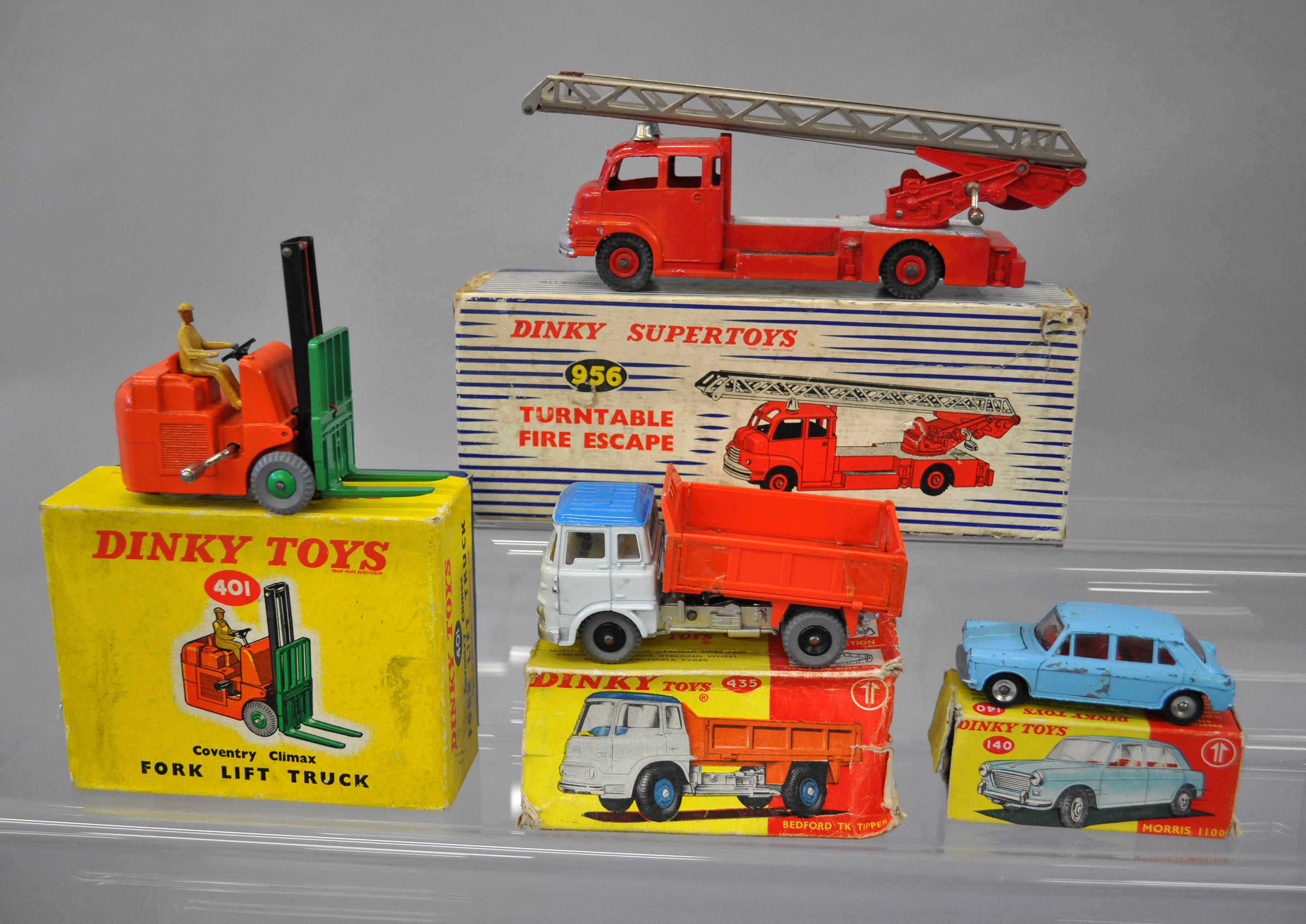 Four Dinky Toys models: 401 Fork Lift Truck; 435 Bedford TK Tipper; 956 Turntable Fire Escape; 140