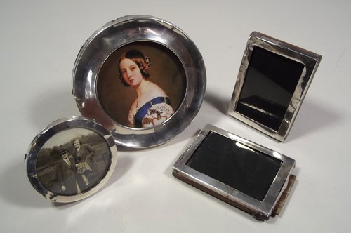 PHOTOGRAPH FRAMES
A pair of small, rectangular, silver mounted frames & two circular silver frames.