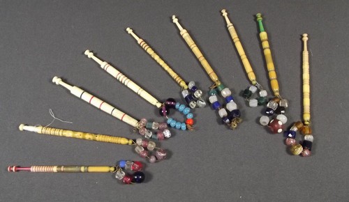 LACE BOBBINS
A collection of nine various turned bone lace bobbins, each with coloured glass