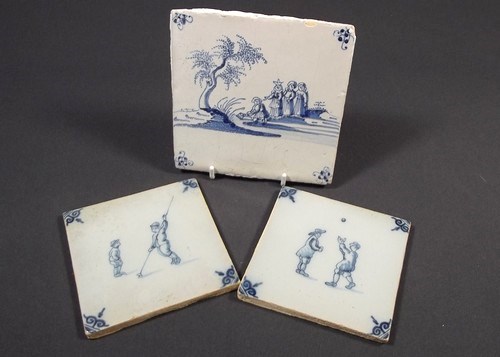 DELFT TILES
A pair of tin glazed 4 ins. tiles decorated with figures playing games & an earlier