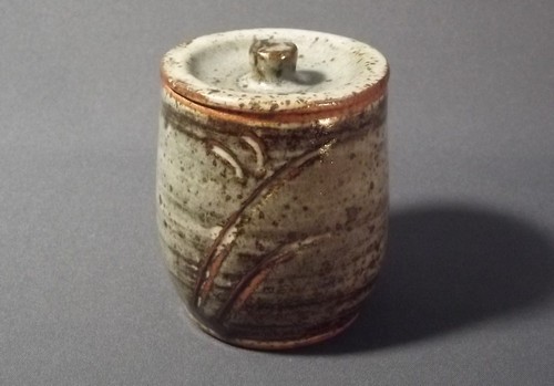 LEACH POTTERY
A Leach Pottery lidded jar with incised decoration. Height 4 1/4 ins. Pottery mark.