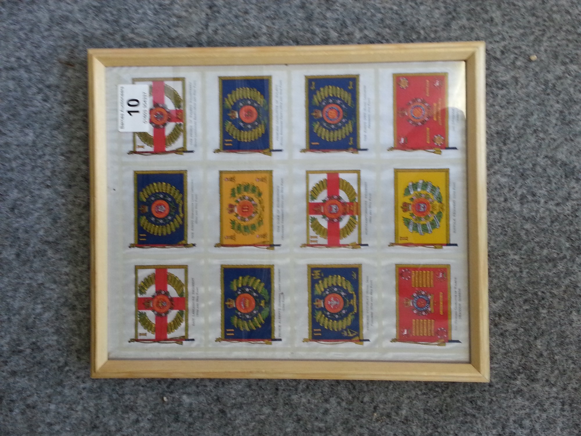 Framed set of twelve uncut silk cigarette cards, Regimental flags, maker unknown but probably