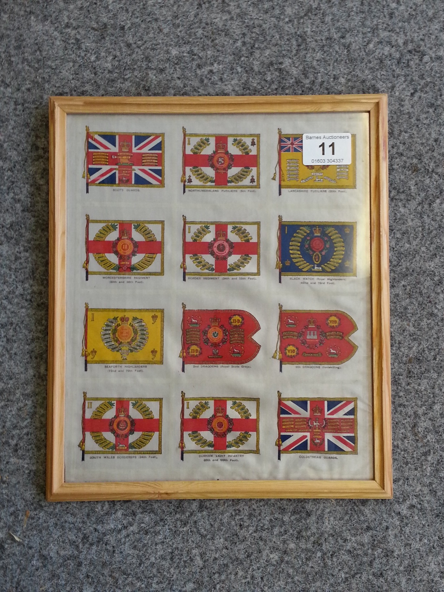 Framed set of twelve uncut silk cigarette cards, Regimental flags, maker unknown but probably