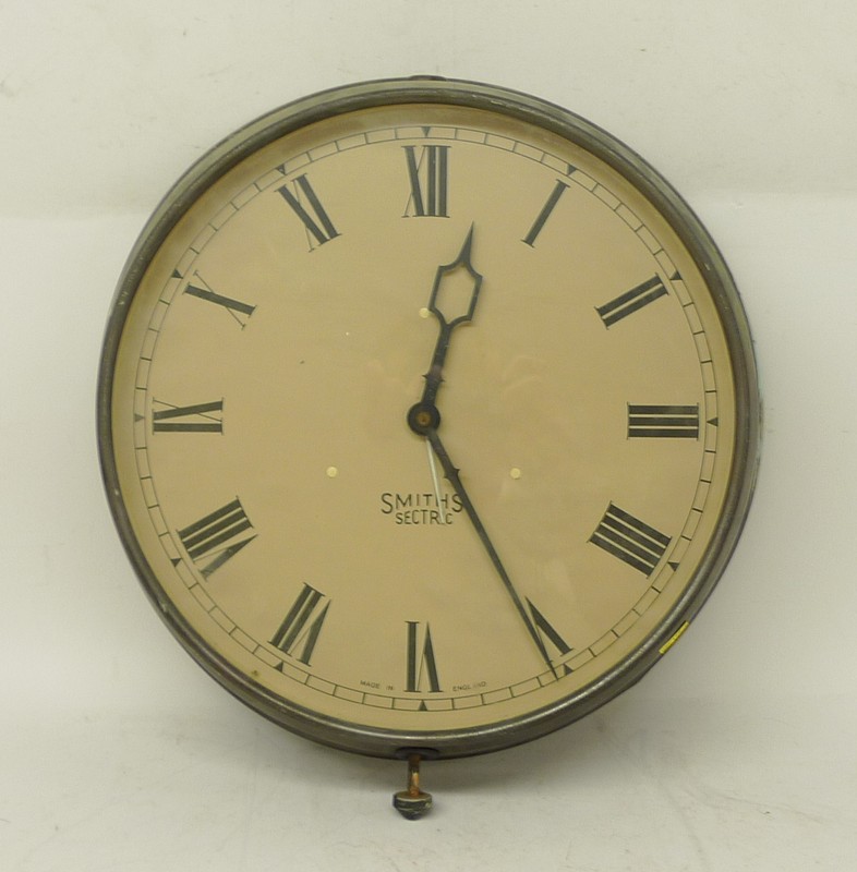 A Smiths sectric wall clock, metal cased, enamel dial bearing Roman numerals, 35 by 17 by 8cm.