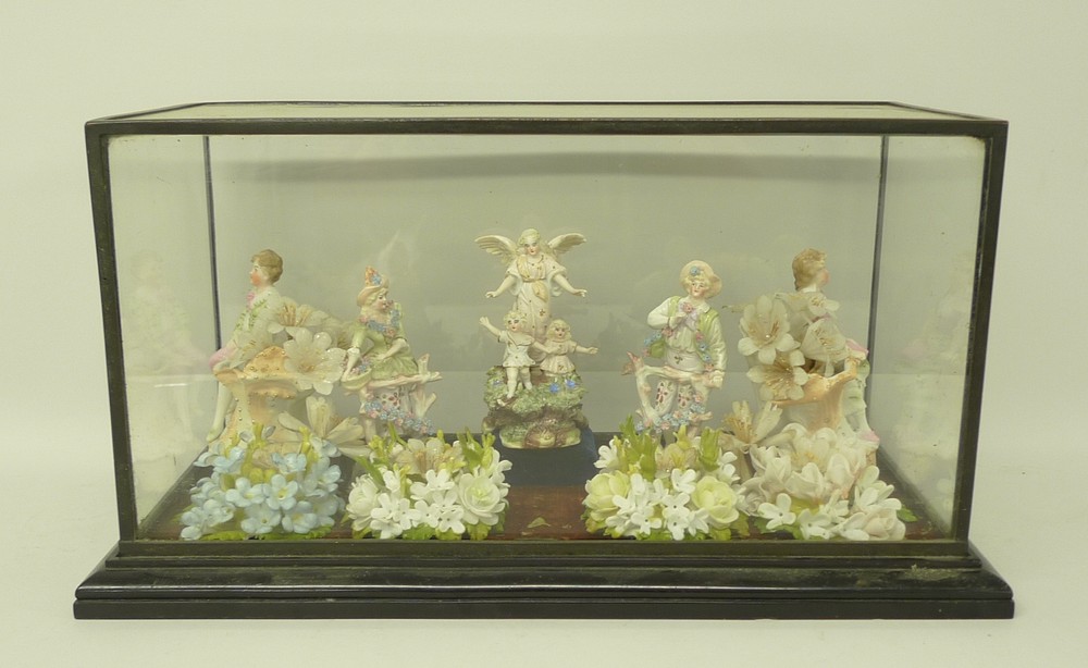 A porcelain montage, late 19th century, formed of five Continental bisque figures behind four