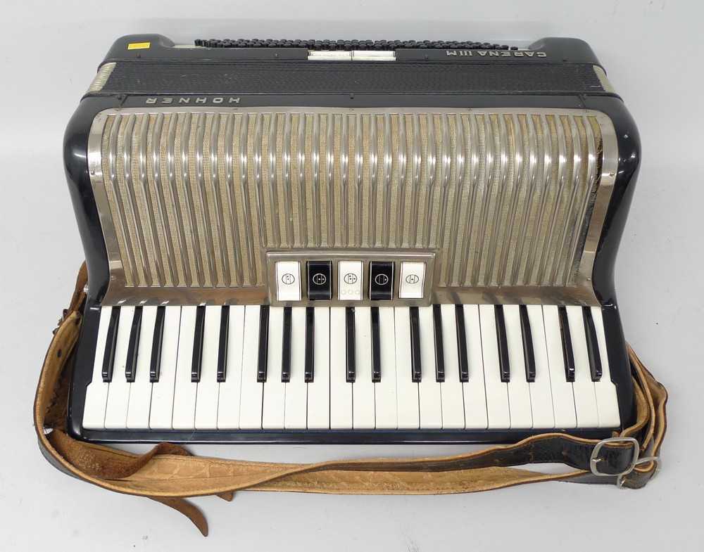 A Hohner Carena IIIM bass accordion, black case with a chrome panel, 120 button, 48 by 37cm.
