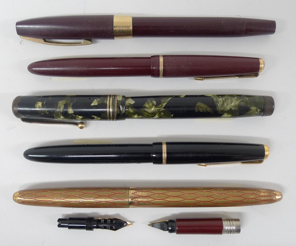 A Swan 1930s Mabie Todd fountain pen with 14k gold nib and mottled green body, two Parker 585