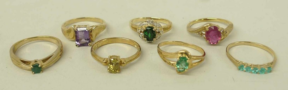 A group of modern 9ct gold rings, comprising; a ruby and white sapphire ring; a Columbian emerald