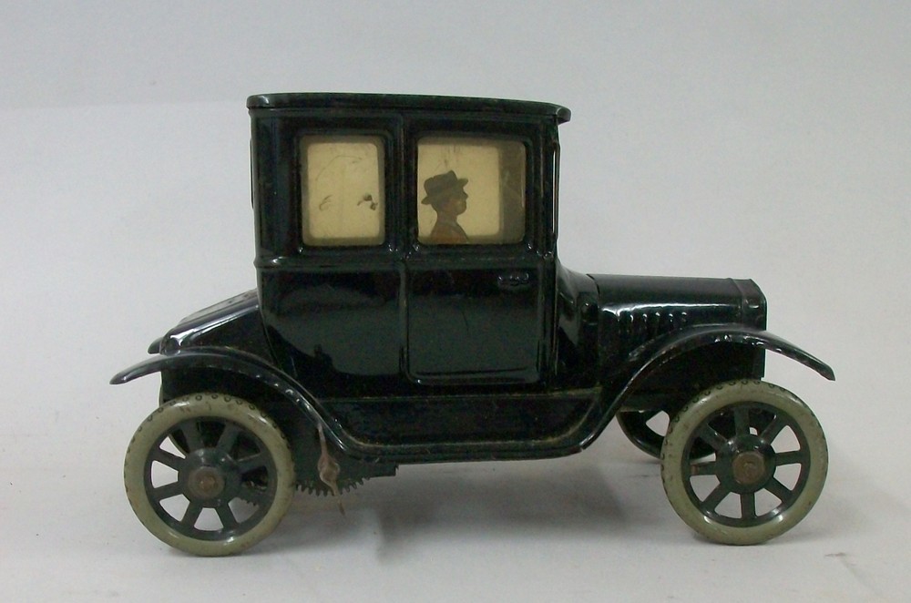 A Bing black tin plate clockwork Model T Ford 'Doctor's Coupe', circa 1920, with a gentleman