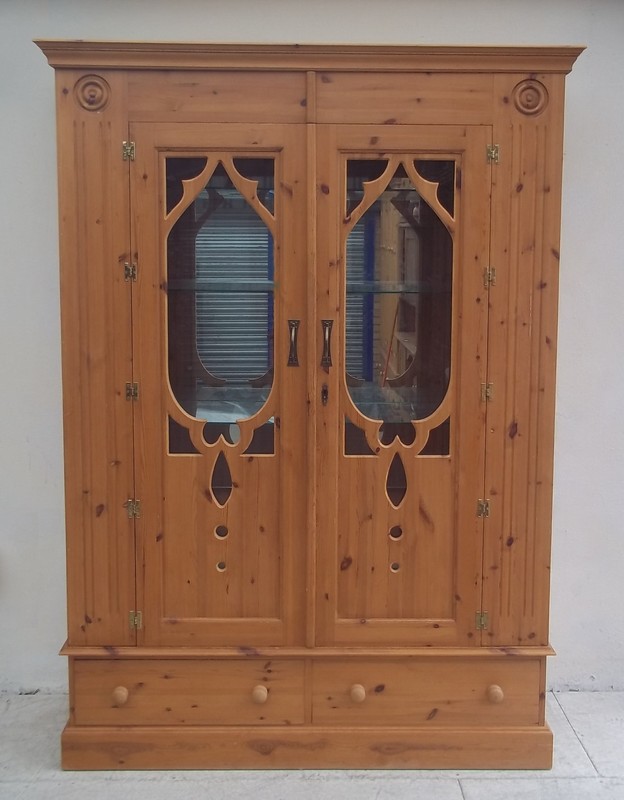 A modern pine armoire with glazed front door and three glass shelves to interior, 145 by 57 by 201cm