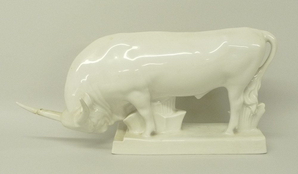 A Zsolnay Pecs, Hungary, white glazed porcelain model of an ox, raised on a rectangular base,