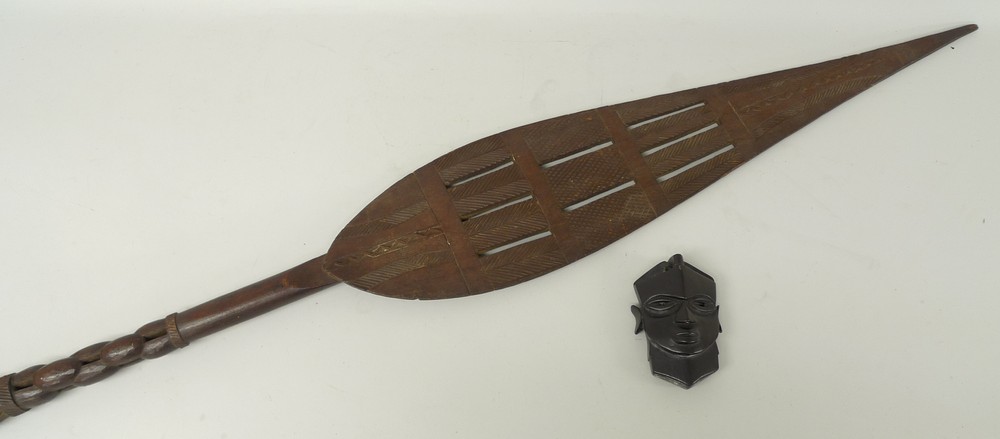 A Solomon Islands decorative paddle, symbol of office, carved and pierced, 163cm long, and an