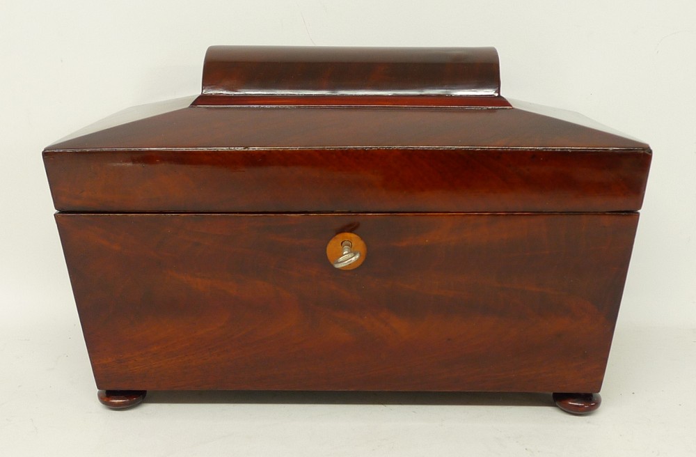 A Regency mahogany tea caddy with turned circular handles, twin section interior with mixing bowl to