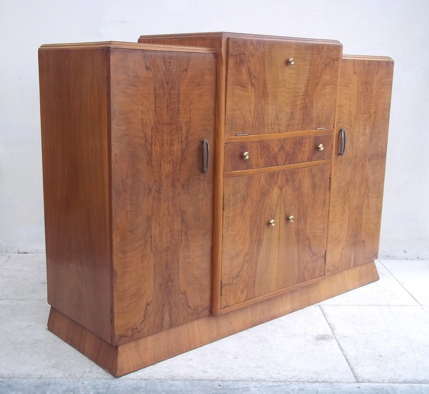 A walnut veneered sideboard/cocktail cabinet, mid 20th century, with lift lid and front revealing