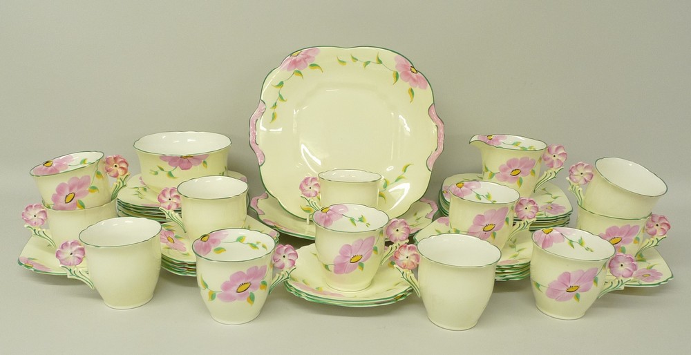 A Collingwood, 1930's, porcelain part tea service painted with flowers and with floral moulded