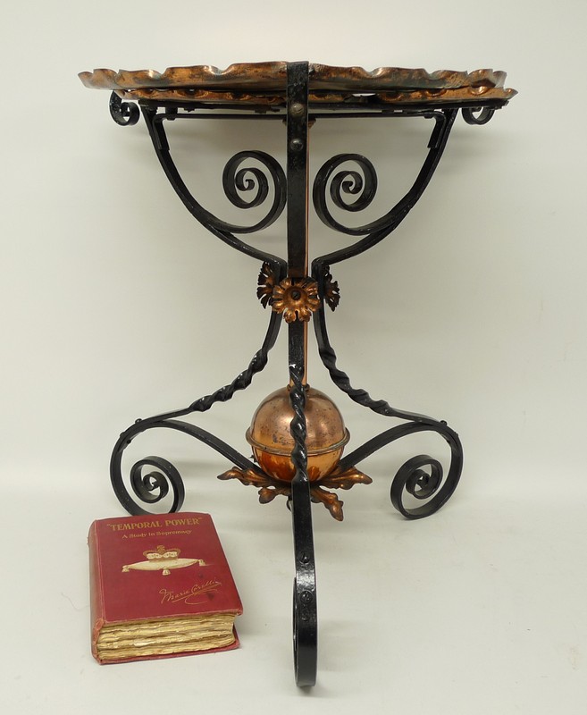 A Victorian copper and cast iron occasional table, the hammered tray top with three smaller pull out