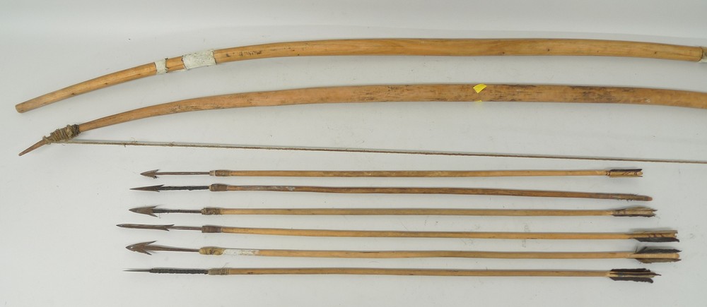 Ethnographic / Tribal: two bows and six arrows, pre war, with iron hand wrought tips, with barbs,