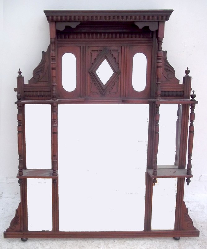 A Victorian mahogany framed over mantel mirror, with super structure of shelves raised on bun