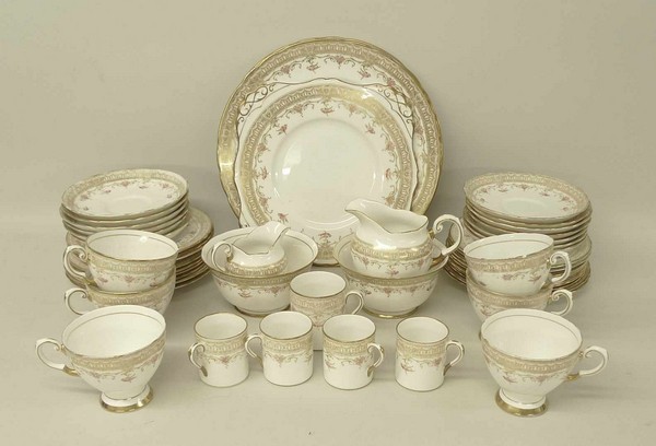 A Tuscan porcelain part tea and coffee service decorated in gilt and pink with floral swags and