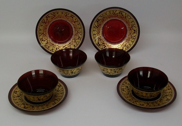 A set of four Continental ruby glass finger bowls and saucers, late 19th century, decorated in