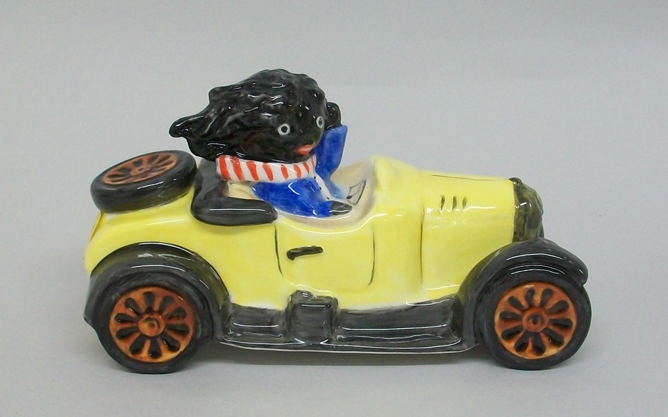A Carltonware pottery trial piece Golly I motor car with seated figure, 12cm long.
