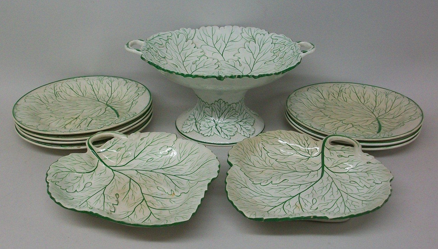 A Staffordshire pottery part dessert service, mid 19th century, with leaf moulded decoration,