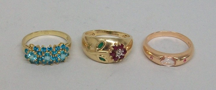 A 9ct gold, ruby, emerald and diamond set floral stem gypsy ring, size Q, 9ct gold and blue topaz