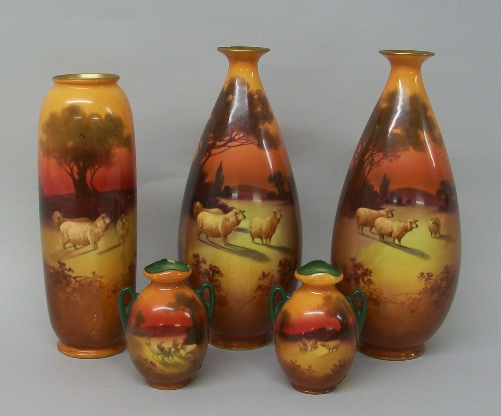 A group of five Royal Doulton pottery vases depicting pastoral scenes with sheep and trees under red