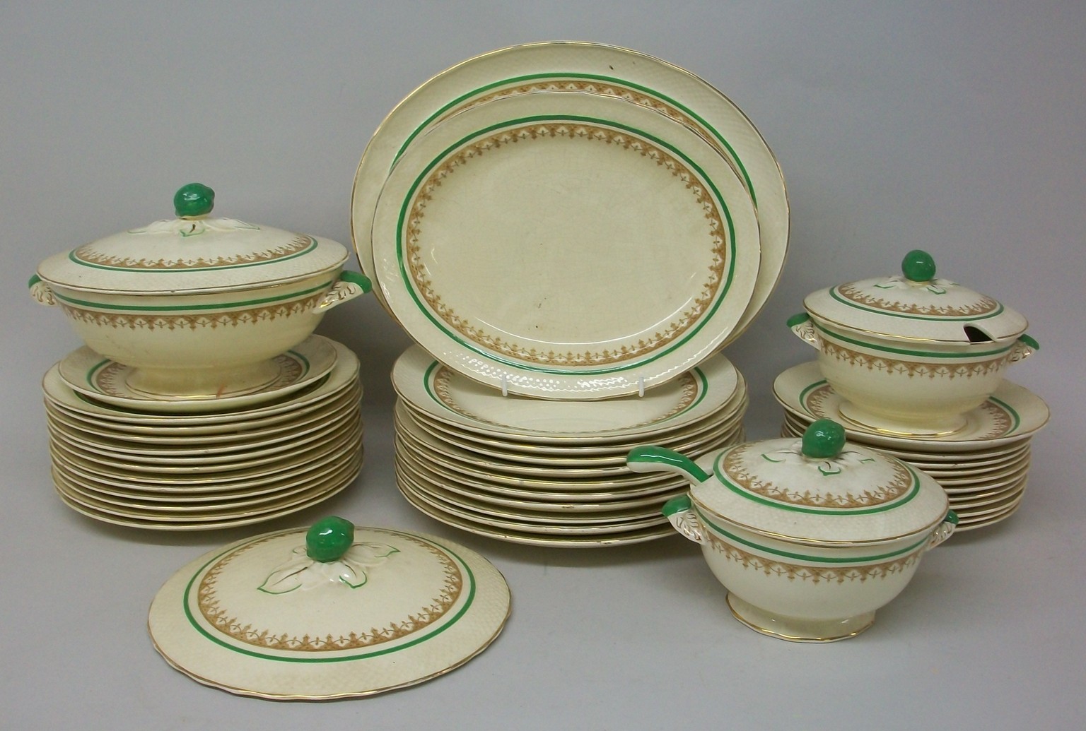 A Furnivals pottery part dinner service, circa 1930s, with brown transfer border, green stripe, fish