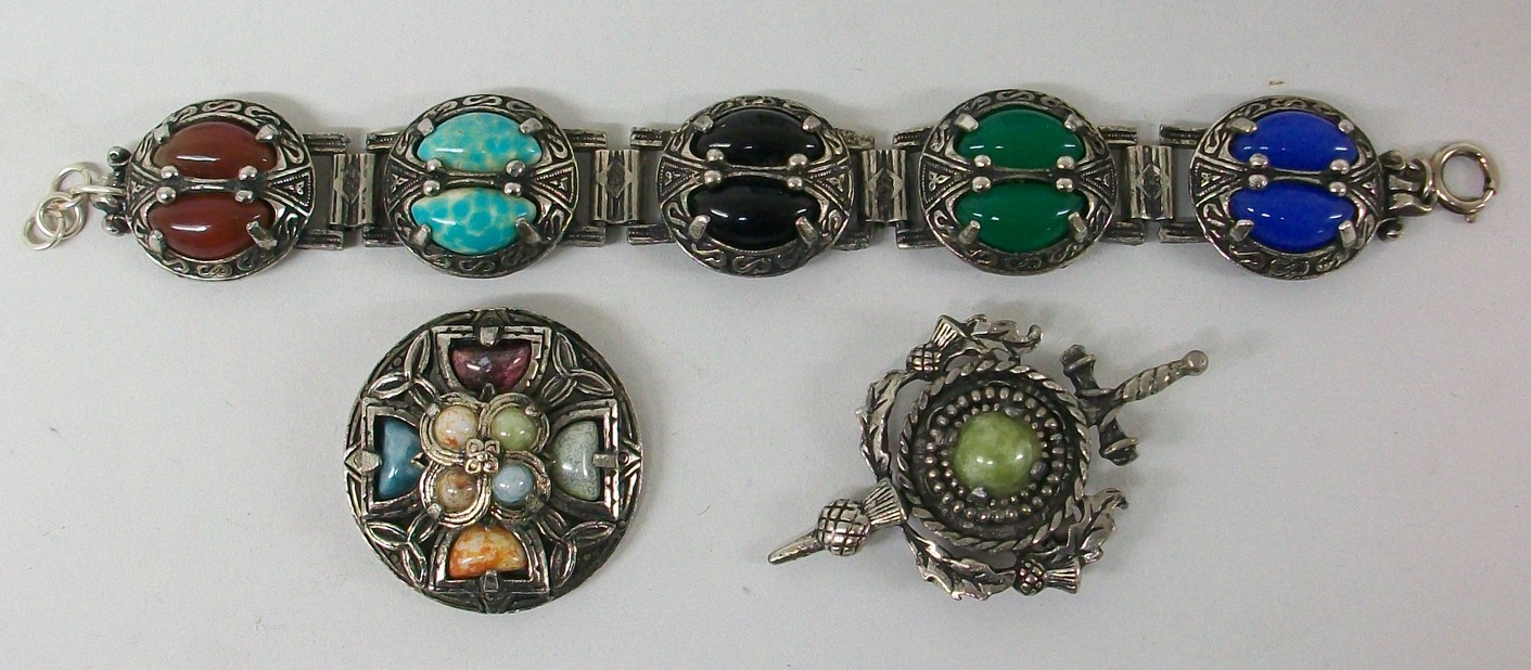 A Celtic style bracelet and two Scottish themed brooches. (3)