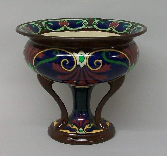 A Foley Intarsio pedestal bowl, decorated with abstract flowers and tendrils on a blue and brown