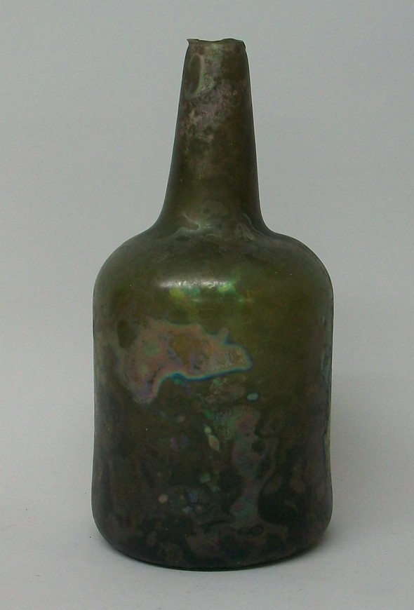 An 18th century green glass bottle, top of neck cut, 23cm high.