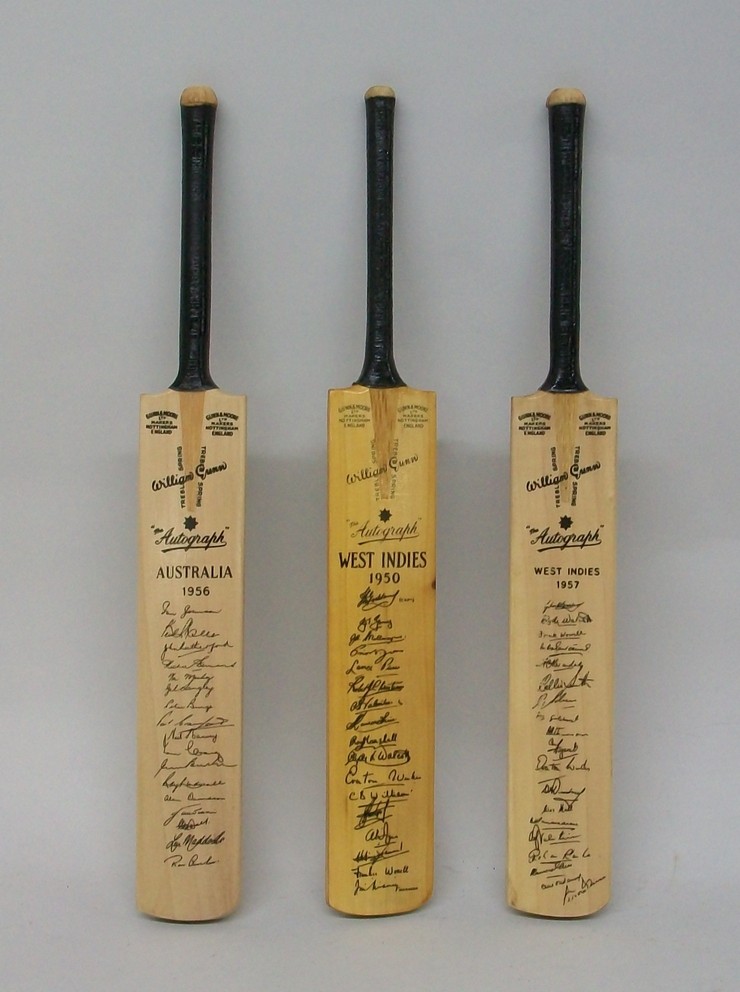 A miniature cricket bat printed with the signatures of the Australian Series 1956, and two further