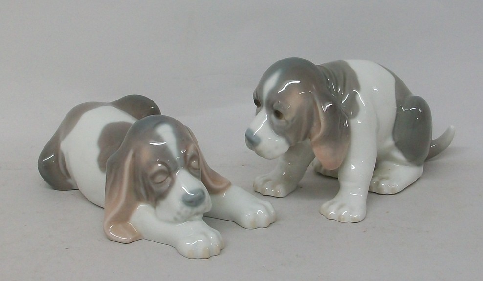 A Lladro porcelain figure modelled as a spaniel puppy, and another similar, printed marks.