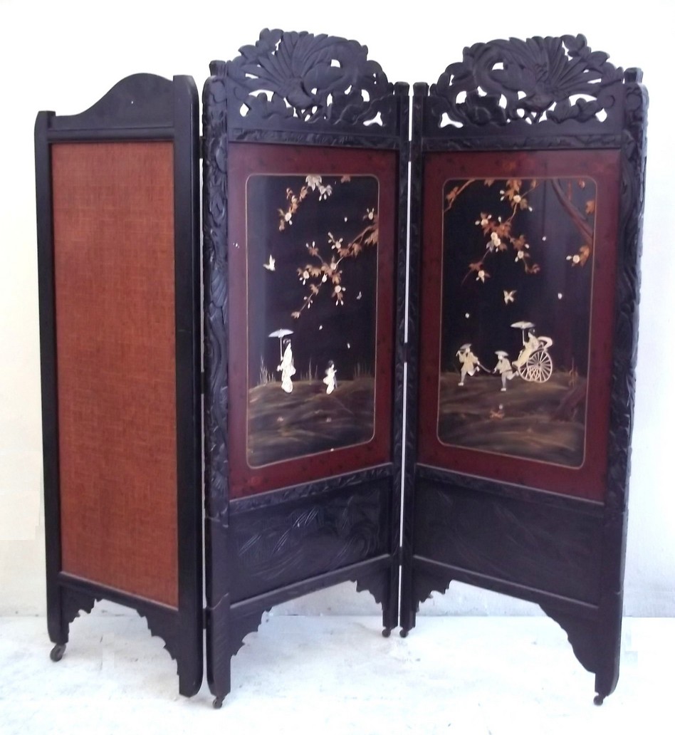 A two fold ebonised and lacquered Shibayama room divider, Meiji period, with two decorated and
