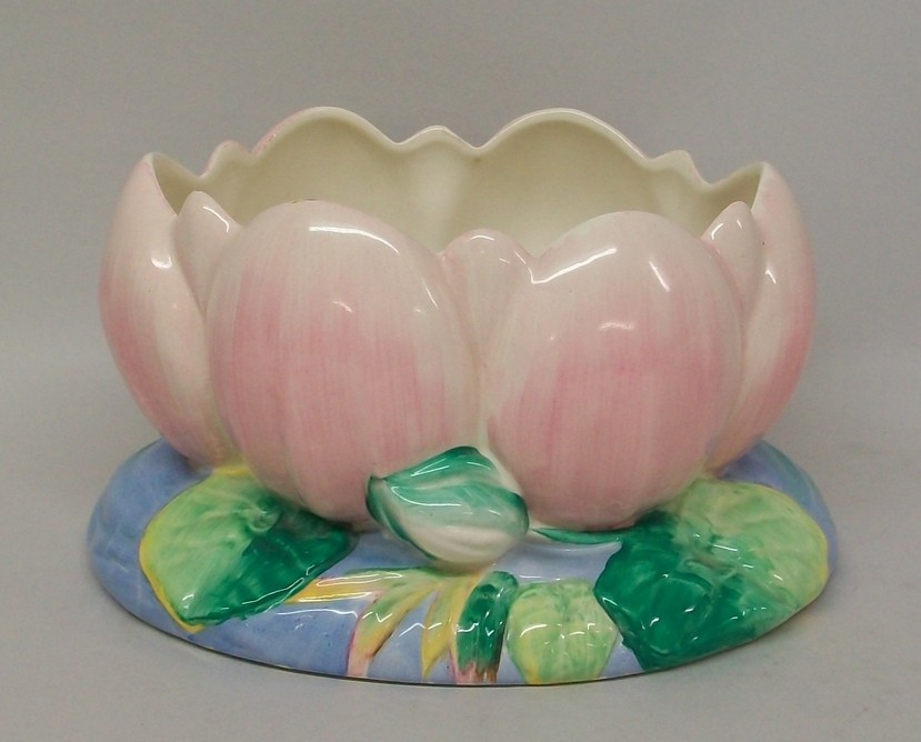 A Clarice Cliff pottery water lily vase on an oval leaf base, printed mark, 22 by 17 by 12cm.