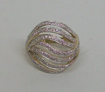 A 9ct gold and diamond set ring in a swirl design, size Q, 6.3g.