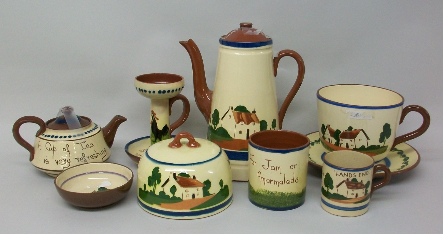 A quantity of Watcombe pottery Mottoware decorated with houses, comprising; coffee pot, breakfast