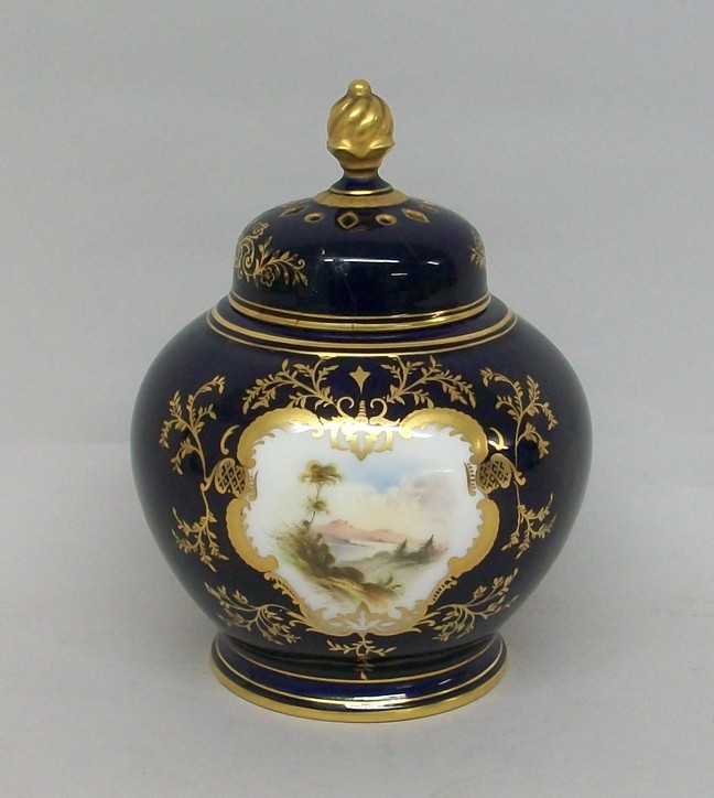 A Coalport porcelain vase and pierced cover, circa 1900, of globular form, reserve decorated with