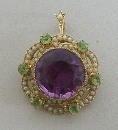 An Edwardian gold, amethyst, demantoid garnet and seed pearl set pendant brooch of circular form